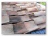 Bitumen sheet is meant to provide some grip to the tiles. The tiles are to cut heat impact on the roofing and to prevent drumming  when it rains
