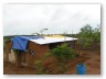 The morning after saw roofing sheets placed loose on the structure and tarps laid to protect the ridge